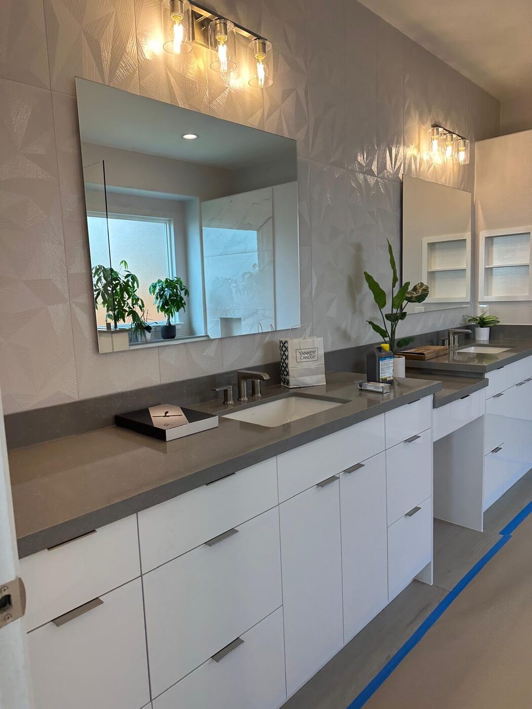 Bright dual-vanity primary bath with a private makeup nook