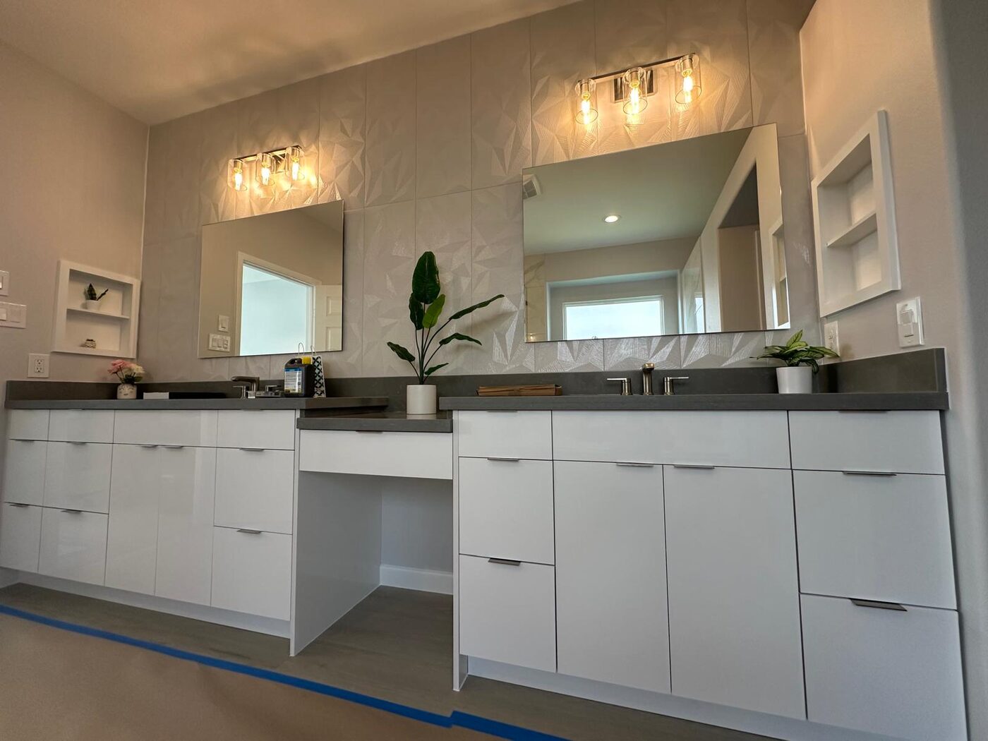 Sleek dual vanity with dimensional tile and a seated vanity nook