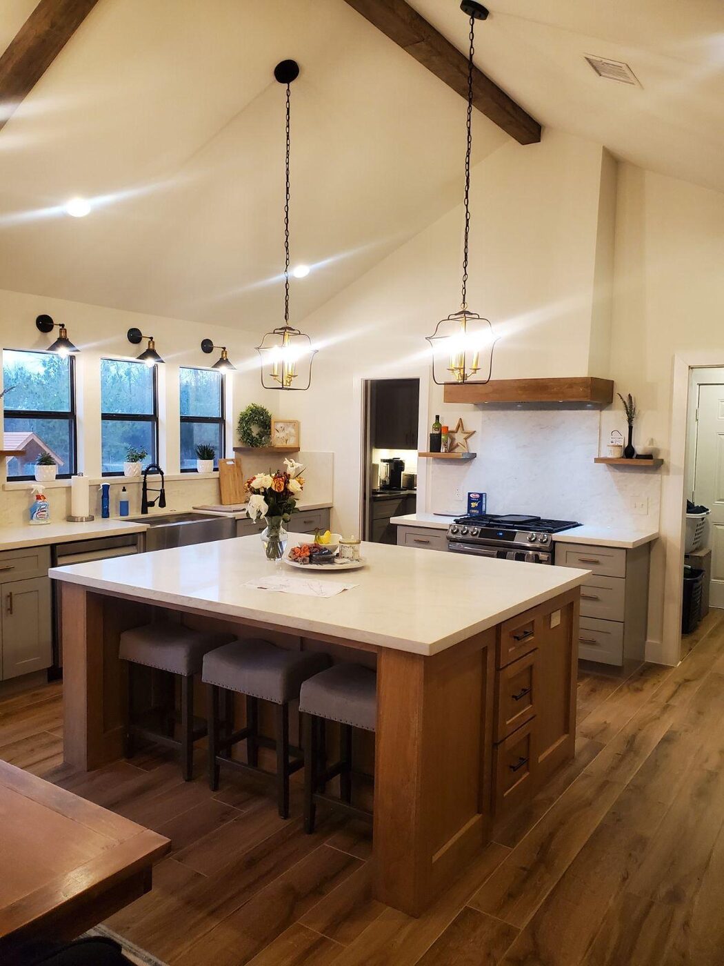 Vaulted-ceiling kitchen with an oversized island and exposed beams