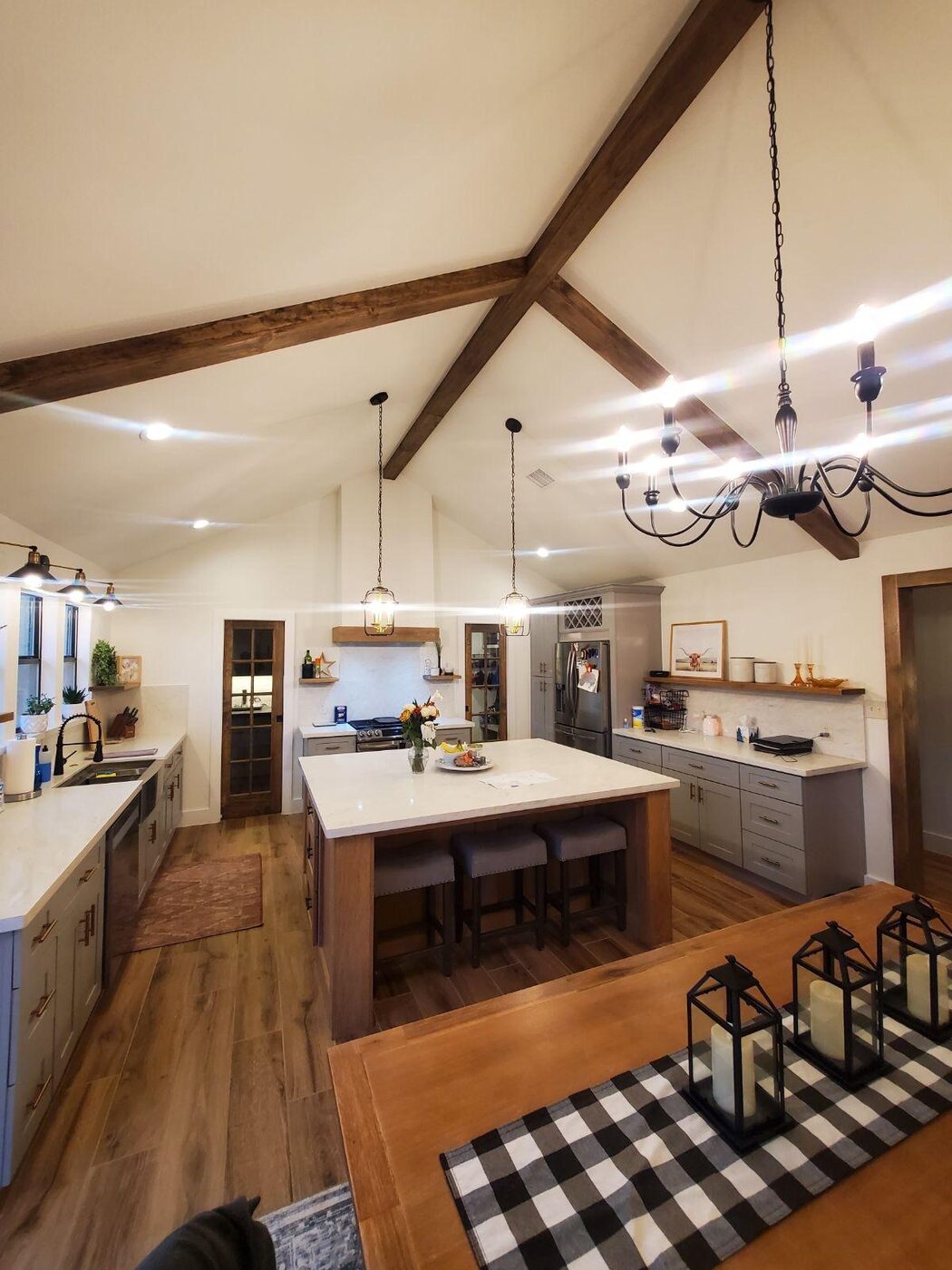 Farmhouse-style kitchen with exposed wood beams and a chandelier