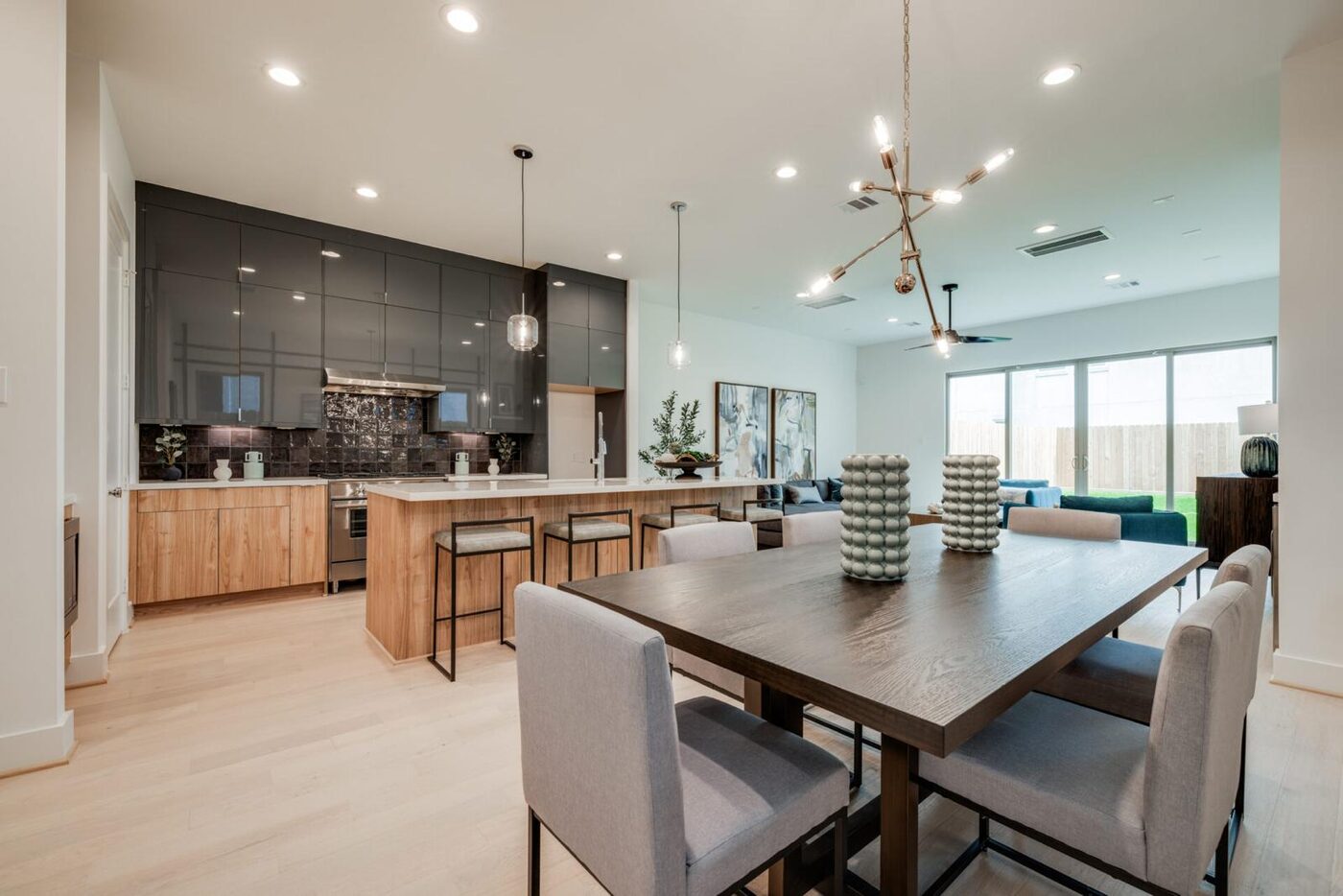 Modern high-gloss cabinetry with a warm walnut island